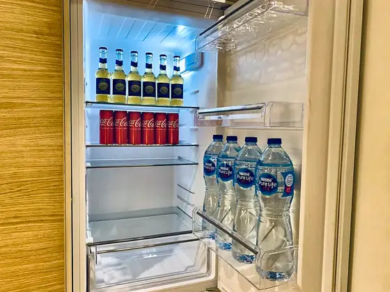 Stocked fridge. Bottled water and cold drinks waiting in the refrigerator.