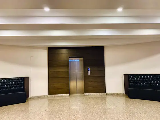 Lift and lobby. A marble-floored lobby with lift and seating on the apartment floor.