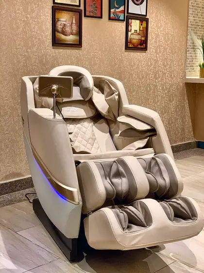Massage chairs and a whirlpool bath. Full-body massage chairs with armrest controls, a double whirlpool jacuzzi and glass rain showers with LED-lit mirrors.