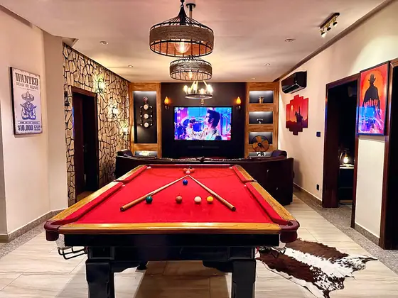Pool and snooker tables. Full-size red-cloth and blue-cloth tables with cues, racks and ball sets.
