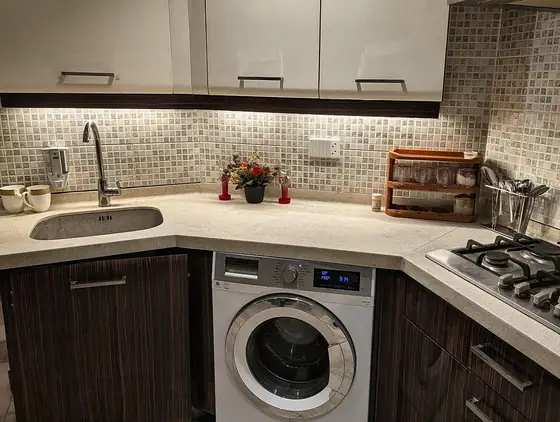 Washing machine. A front-load washing machine built into the kitchen.