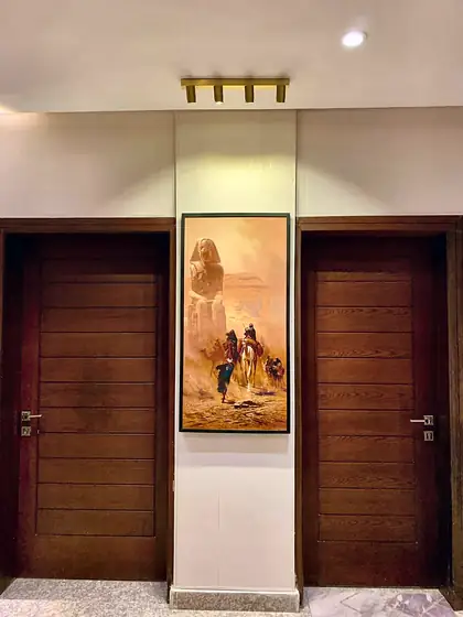 Entrance hall with double doors and a desert painting.
