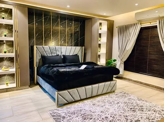 Bedroom angle showing both illuminated display units and the geometric rug.